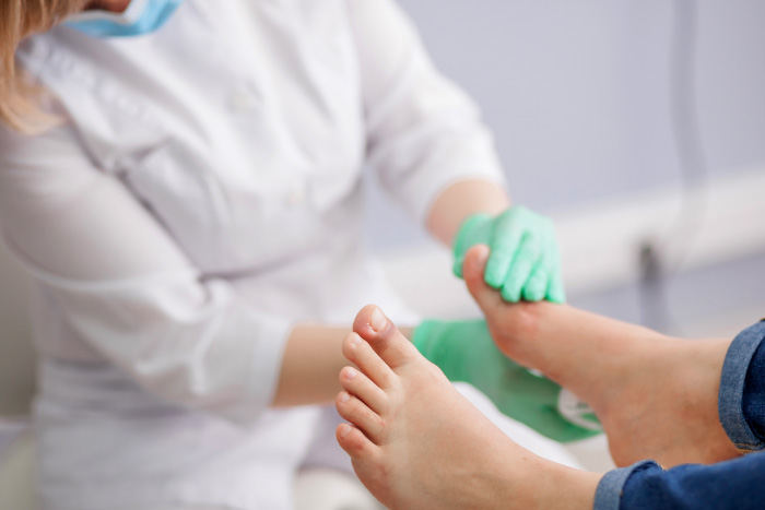 Medical professional check a diabetic's feet.